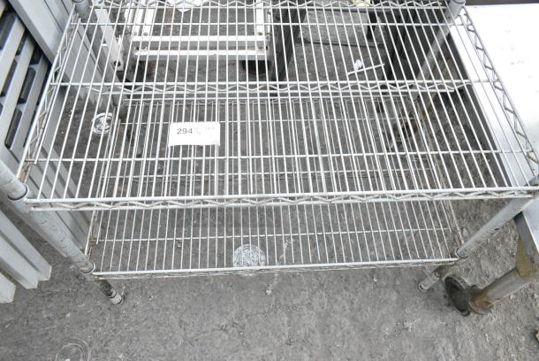 Chrome Finish 2 Tier Wire Shelving Unit. BUYER MUST DISMANTLE. PCI CANNOT DISMANTLE FOR SHIPPING. PLEASE CONSIDER FREIGHT CHARGES. - Image 1 of 2
