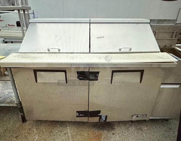 One WORKING True 2 Door Refrigerated Prep Table With 2 Racks, And Cutting Board On Casters. Model# TSSU-60-24M-B-ST. 115 Volt. 60X34X48 - Image 1 of 1