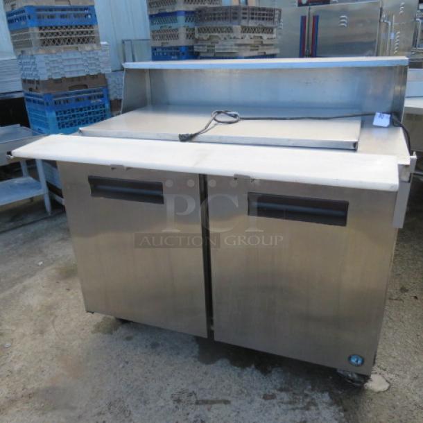 One Hoshizaki 2 Door Refrigerated Prep Table With 2 Racks On Casters. Model# CRMR48-18M. 115 Volt. 48X38X45. $4860.00. - Image 2 of 3