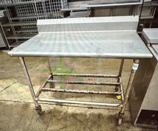 One Stainless Steel Table With Back Splash On Casters. 48X30X39.5