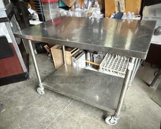 One Stainless Steel Table With SS Under Shelf On Casters. 48X30X35