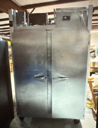 One Traulsen  2 Door Freezer With 5 Racks On Casters. Not Working. Model# G22010. 52X34.5X84