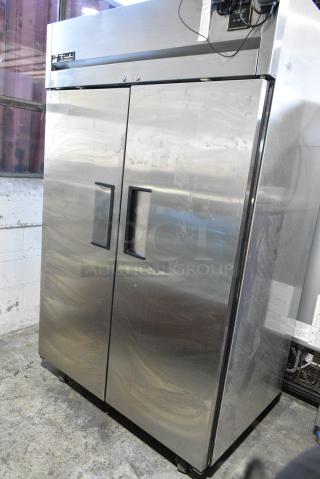 True TG2R-2S Stainless Steel Commercial 2 Door Reach In Cooler w/ Poly Coated Racks on Commercial Casters. 115 Volts, 1 Phase. Tested and Working!