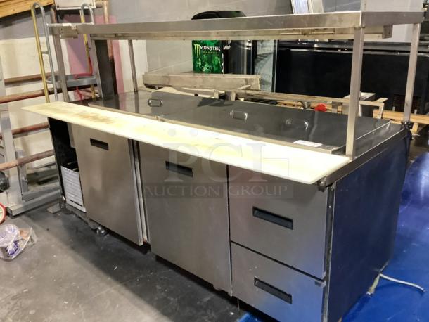 Randell Stainless Steel Dual-Sided Work Island/Cold Buffet Bar. 
Multi-Pan Prep Table W/Two-Door and Two Drawers  Refrigerated Storage. Tested And Working. 
84 x  46/52 x 58 - Image 1 of 14