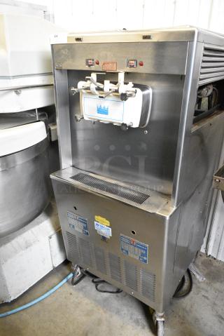 Taylor 339-33 Stainless Steel Commercial Water Cooled Floor Style 2 Flavor w/ Twist Soft Serve Ice Cream Machine on Commercial Casters. 208/230 Volts, 3 Phase.