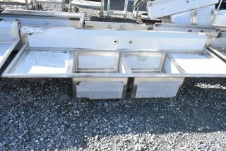 BRAND NEW SCRATCH AND DENT! Regency 600S22323224 Stainless Steel Commercial 2 Bay Sink w/ Dual Drain Boards. No Legs. Bays 23x23x12. Drain Boards 22x24
