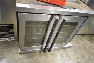 Stainless Steel Commercial Natural Gas Powered Full Size Convection Oven w/ View Through Doors, Metal Oven Racks and Thermostatic Controls.
