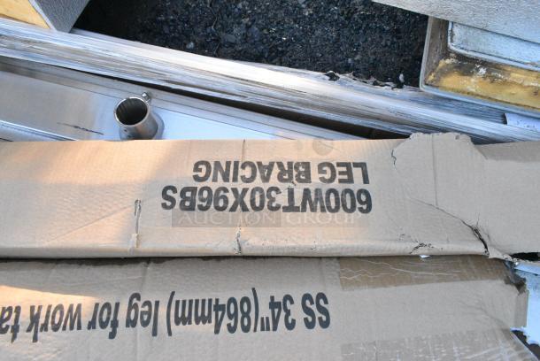 BRAND NEW SCRATCH AND DENT! Regency 600WT30X96BS 30" x 96" 16-Gauge 304 Stainless Steel Commercial Open Base Work Table with 4" Backsplash. May Be Missing Pieces. - Image 2 of 3