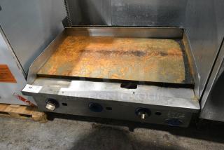 Globe Stainless Steel Commercial Countertop Natural Gas Powered Flat Top Griddle.