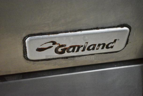 Garland Stainless Steel Commercial Natural Gas Powered 4 Burner Range w/ Oven, Over Shelf and Back Splash on Commercial Casters. - Image 2 of 7