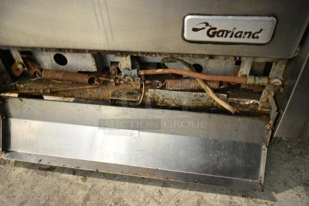 Garland Stainless Steel Commercial Natural Gas Powered 4 Burner Range w/ Oven, Over Shelf and Back Splash on Commercial Casters. - Image 6 of 7