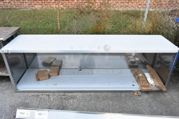 BRAND NEW SCRATCH AND DENT! Regency 600EBT2496 24" x 96" 16 Gauge Type 304 Stainless Steel Enclosed Base Table with Open Front and Adjustable Midshelf - Image 1 of 6