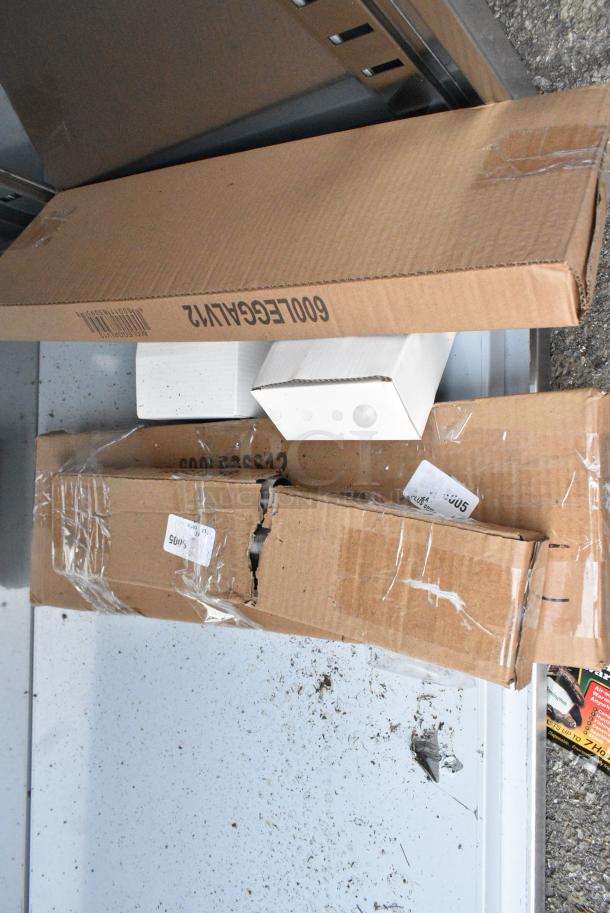 BRAND NEW SCRATCH AND DENT! Regency 600EBT2496 24" x 96" 16 Gauge Type 304 Stainless Steel Enclosed Base Table with Open Front and Adjustable Midshelf - Image 4 of 6