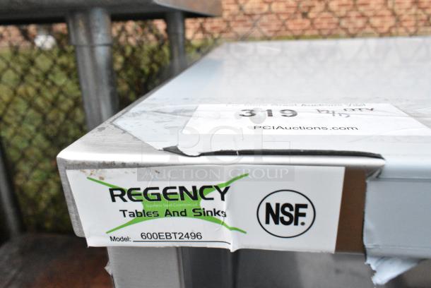 BRAND NEW SCRATCH AND DENT! Regency 600EBT2496 24" x 96" 16 Gauge Type 304 Stainless Steel Enclosed Base Table with Open Front and Adjustable Midshelf - Image 6 of 6