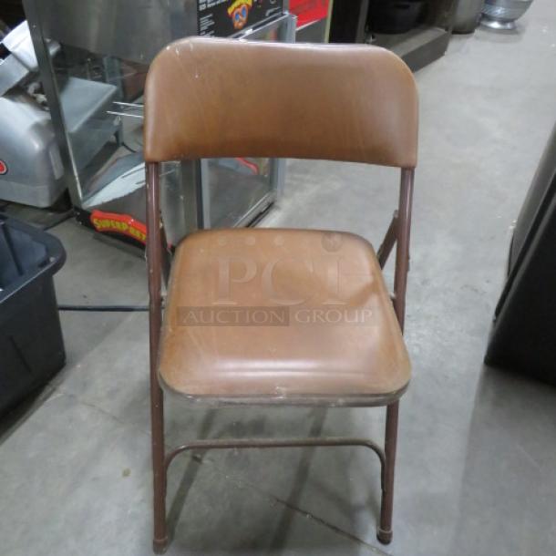 Brown Metal Folsing Chair With Cushioned Seat And Back. 4XBID - Image 1 of 1
