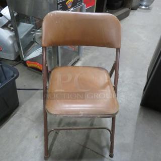 Brown Metal Folsing Chair With Cushioned Seat And Back. 4XBID