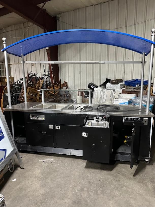One Kiosk With A Pull Out Hand Sink, 2 Door Under Storage, Glass Serving/Over Shelf, 2 Hot Wells, 1 Cold Well, Cash Drawer, And A Canopy On Casters. 116X36X94 - Image 1 of 5