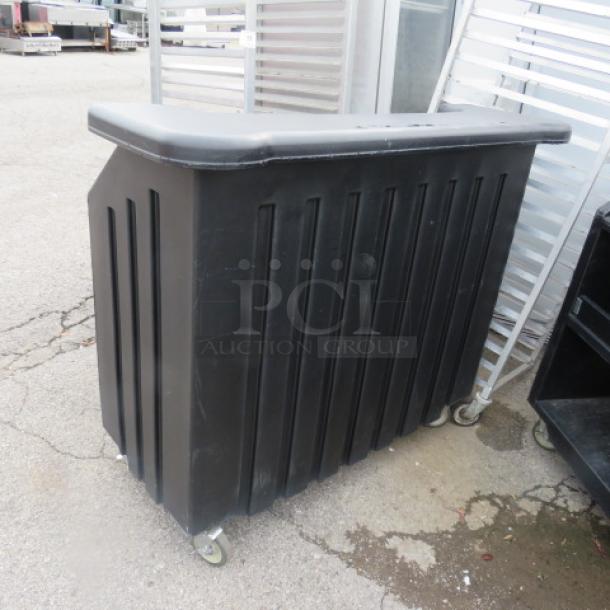 One Black Poly Portable Bar With Ice Well, Storage Serving Shelf, And A Bottle Rail On Casters. 53X32X47 - Image 1 of 2