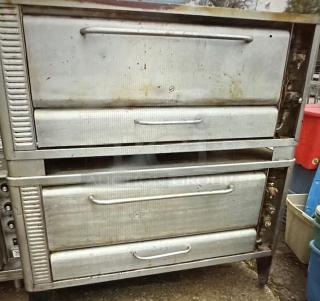 One Blodgett Double Stack Natural Gas Deck Pizza Oven. 1 Cracked Stone Working When Removed. Model# 1048B. 60X48X64.
