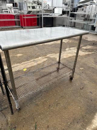 One Stainless Steel Table With A Metro Under Shelf On Casters. 49.5X24X40