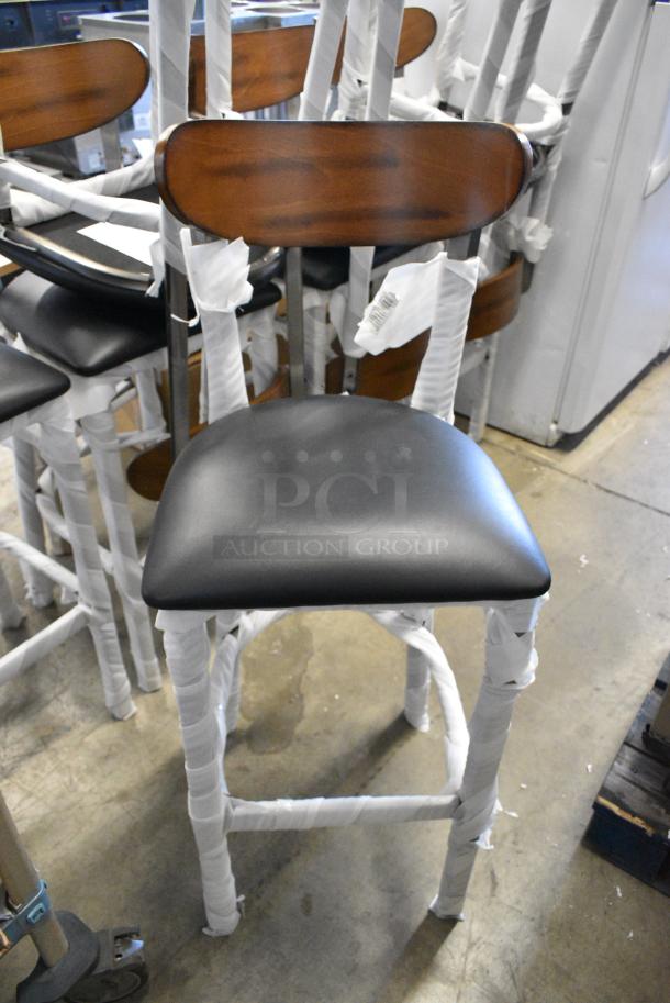 8 BRAND NEW SCRATCH AND DENT! Lancaster Table & Seating 164BBMRNG  Boomerang Series Black Finish Bar Stool with Black Vinyl Seat and Antique Walnut Wood Back. 8 Times Your Bid! - Image 1 of 5