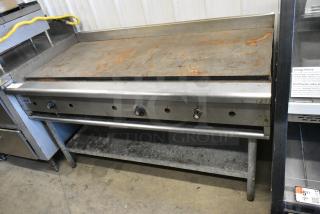 Royal Stainless Steel Commercial Countertop Natural Gas Powered Flat Top Griddle on Stainless Steel Equipment Stand.