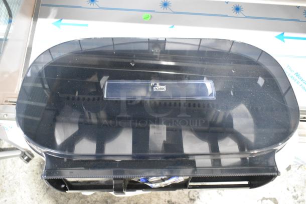 BRAND NEW SCRATCH AND DENT! Tork Poly Wall Mount Toilet Paper Dispenser - Image 1 of 4