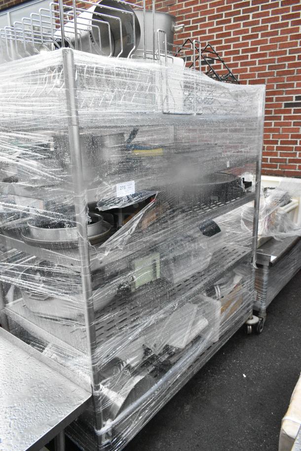 Chrome Finish 5 Tier Wire Shelving Unit on Commercial Casters w/ Contents Including Pizza Pan Rack, Metal Stock Pots, Gas Hoses, Round Metal Pans. BUYER MUST DISMANTLE. PCI CANNOT DISMANTLE FOR SHIPPING. PLEASE CONSIDER FREIGHT CHARGES. - Image 1 of 11