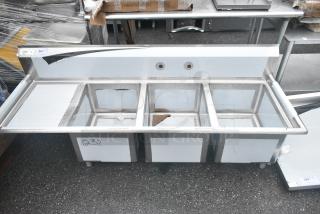 BRAND NEW SCRATCH AND DENT! Regency 600S3162018L Stainless Steel 3 Bay Sink w/ Left Side Drain Board. No Legs. - Item #1156137