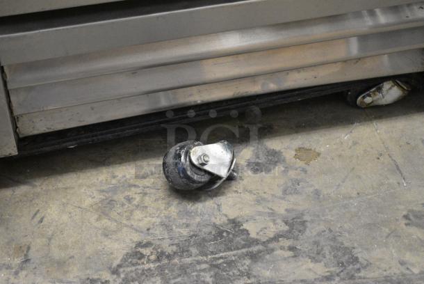 True T-19F Stainless Steel Commercial Single Door Reach In Freezer w/ Poly Coated Racks on Commercial Casters. 1 Caster Needs To Be Reattached. 115 Volts, 1 Phase. Tested and Working! - Image 2 of 5
