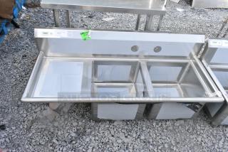 BRAND NEW SCRATCH AND DENT! Regency 600S2171718L 57" 16 Gauge Stainless Steel Two Compartment Commercial Sink w/ 1 Drainboard - 17" x 17" x 12" Bowls - Left Drainboard. No Legs.