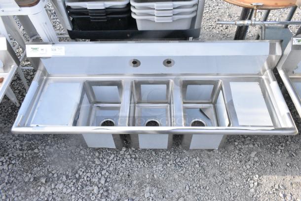 BRAND NEW SCRATCH AND DENT! Regency 600S31014212 58" 16-Gauge Stainless Steel Three Compartment Commercial Sink w/ 2 Drainboards - 10" x 14" x 10" Bowls. No Legs. - Image 1 of 4