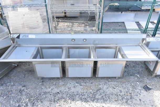 BRAND NEW SCRATCH AND DENT! Regency 600S31818218 94" 16 Gauge Stainless Steel Three Compartment Commercial Sink with Cross Bracing and 2 Drainboards - 18" x 18" x 14" Bowls. No Legs. - Image 1 of 5