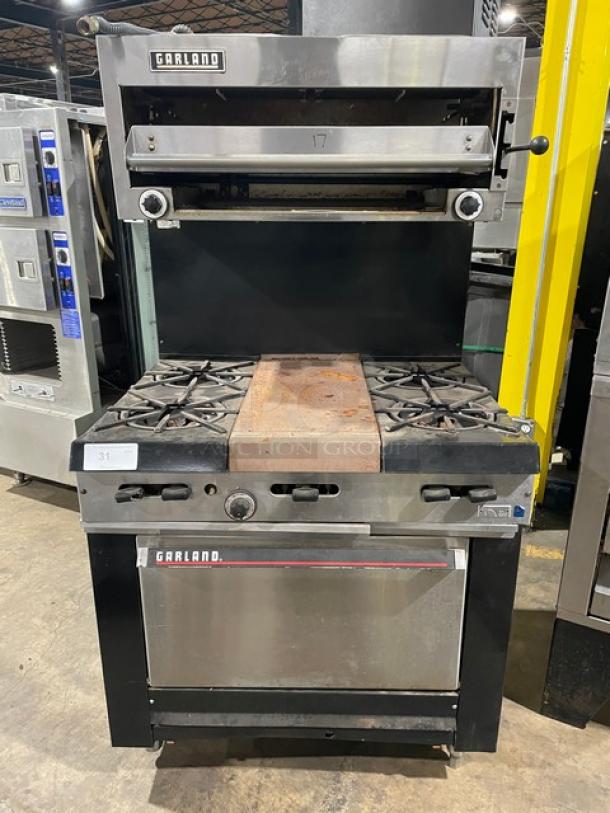 Garland Commercial Stainless Steel Natural Gas Powered 4 Burner Range/Flat Griddle Split Top & Oven Combo! With Wired Oven Rack! With Back Splash & Garland Natural Gas Powered Salamander Broiler/Cheese Melter Overhead! On Legs! - Image 1 of 10