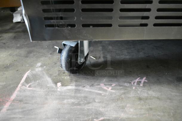 BRAND NEW SCRATCH AND DENT! 2024 Avantco 178SSPPT3 Stainless Steel Commercial 3 Door Refrigerated Pizza Prep Table on Commercial Casters. 115 Volts, 1 Phase. Tested and Working! - Image 4 of 13