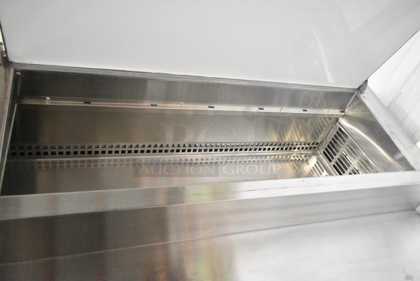 BRAND NEW SCRATCH AND DENT! 2024 Avantco 178SSPPT3 Stainless Steel Commercial 3 Door Refrigerated Pizza Prep Table on Commercial Casters. 115 Volts, 1 Phase. Tested and Working! - Image 6 of 13