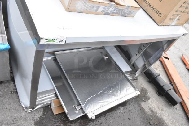 BRAND NEW SCRATCH AND DENT! Regency 600EBT3048D 30" x 48" 16 Gauge Type 304 Stainless Steel Enclosed Base Table with Sliding Doors and Adjustable Midshelf - Image 1 of 4
