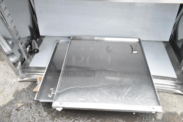 BRAND NEW SCRATCH AND DENT! Regency 600EBT3048D 30" x 48" 16 Gauge Type 304 Stainless Steel Enclosed Base Table with Sliding Doors and Adjustable Midshelf - Image 2 of 4