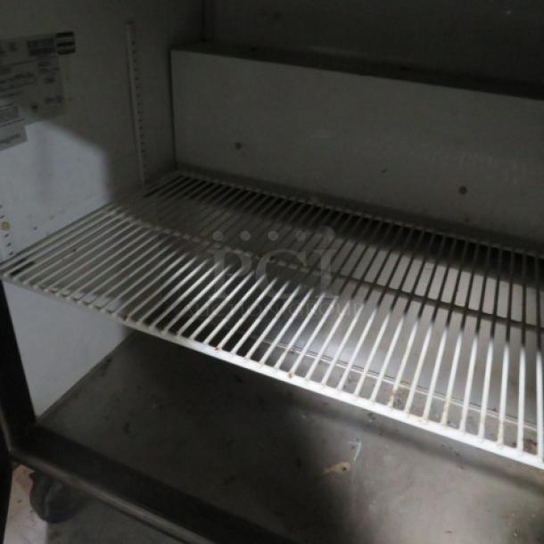 One WORKING  True 2 Door Refrigerated Prep Table With Cutting Board, And 2 Racks On Casters. Model# TSSU60. 115 Volt. 60X34X46. $4803.17 - Image 2 of 2