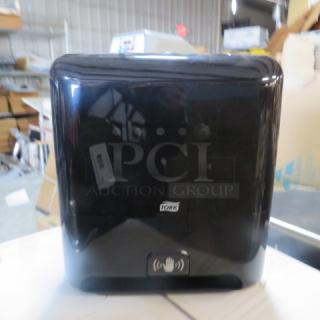 One Tork Hands Free Automatic Paper Towel Dispenser.