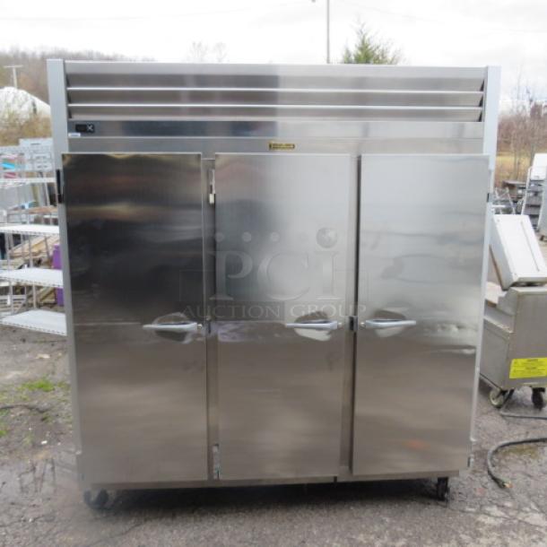 One WORKING  Traulsen 3 Door Refrigerator With 9 Racks On Casters. Model# G30011. 115 Volt. 76X32X84. $8510.36 - Image 1 of 4