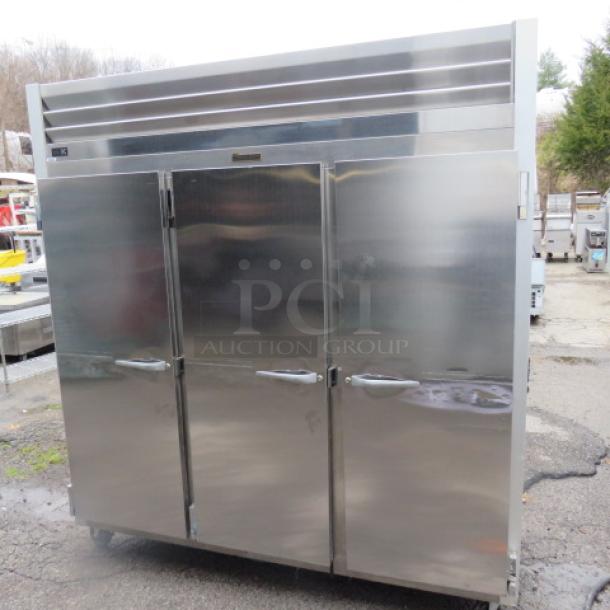 One WORKING  Traulsen 3 Door Refrigerator With 9 Racks On Casters. Model# G30011. 115 Volt. 76X32X84. $8510.36 - Image 2 of 4