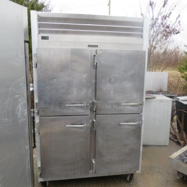 One Traulsen 2 Section  Dutch Door Refrigerator On Casters. Model# G20003. 115 Volt. 52X5X83.5. $6594.00 - Image 1 of 2