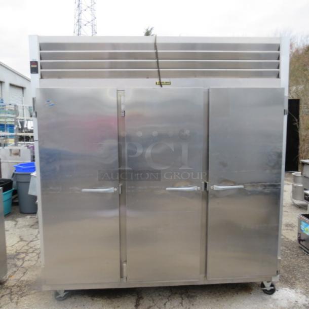 One WORKING Traulsen 3 Door Refrigerator With 9 Racks, On Casters. Model# G30011. 115 Volt. 76X32X84. $8510.36. - Image 1 of 4