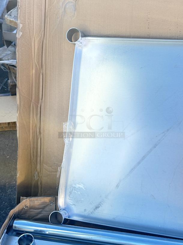 BRAND NEW! "Steelton 30" x 72" 18-Gauge Stainless Steel Equipment Stand with Undershelf and Galvanized Legs. In original packaging, unit has some easily fixable denting/bending (see photos). - Image 5 of 7