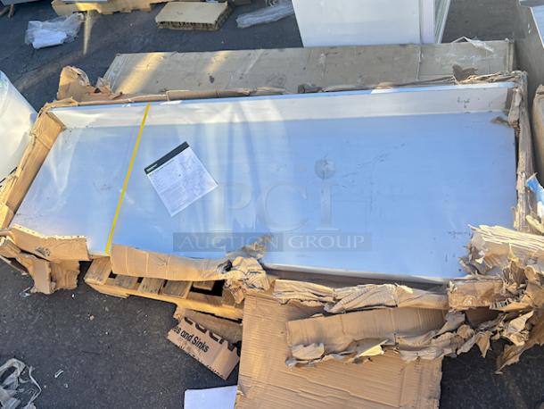 BRAND NEW SCRATCH & DENT! Regency 522SG3072 24" x 72" 18-Gauge 304 Stainless Steel Commercial Work Table with 4" Backsplash and Galvanized Undershelf. Original packaging is damaged. Minor/almost Non-Observable Scratch/Denting. (see photos...come in-person to preview). - Image 1 of 2