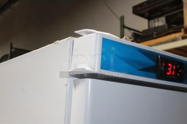 BRAND NEW SCRATCH & DENT! IN PERFECT WORKING ORDER!! Koolmore KM-FMD20WH 21 Cu. ft. Commercial Reach-in Freezer in White Manual Defrost, 115v. 27.4" x 30.1" x 74.4" 
Base and top of unit are dented. See Photos. TESTED! WORKS PERFECT!
*This unit is located at our main warehouse approximately 10mins away. The address is 3290 S. Highland Dr. Las Vegas NV 89109.* - Image 10 of 11