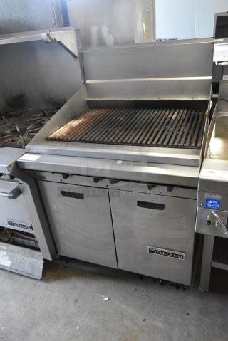 Garland M34B Stainless Steel Commercial  Natural Gas Powered Charbroiler Grill w/ Back Splash, 2 Doors and Under Shelf.