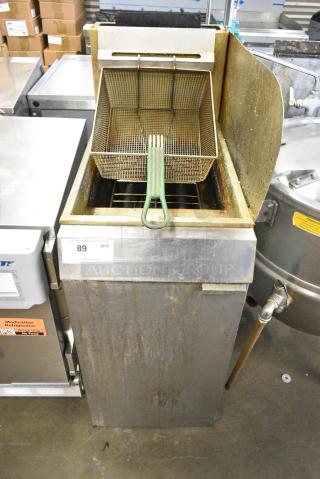 Stainless Steel Commercial Floor Style Natural Gas Powered Deep Fat Fryer w/ Metal Fry Basket and Side Splash Guard.
