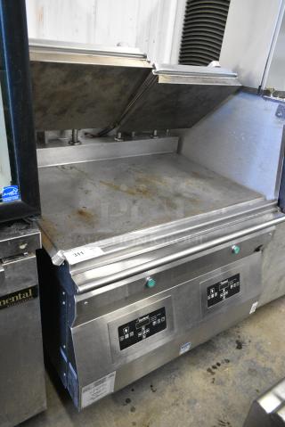 Garland GWG2W-1 Stainless Steel Commercial Natural Gas Powered Clamshell Panini Press Flat Top Griddle on Commercial Casters.
